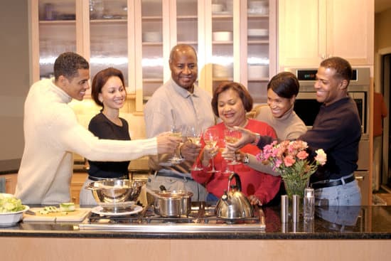 Extended family toasting wine in kitchen